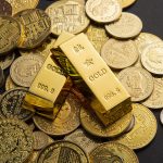 coins-gold-bars-scattered-table.jpg